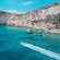 A Zodiac boat speeding through waters near the Sella del Diavolo promontory in the Gulf of Cagliari